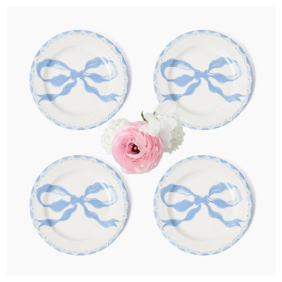 White and blue ceramic plates with blue bow in middle